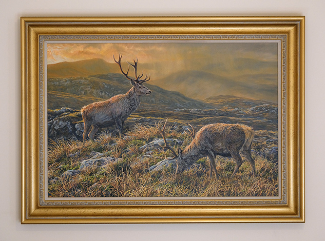 Framed original oil painting of  two red deer stags in mountain scenery.